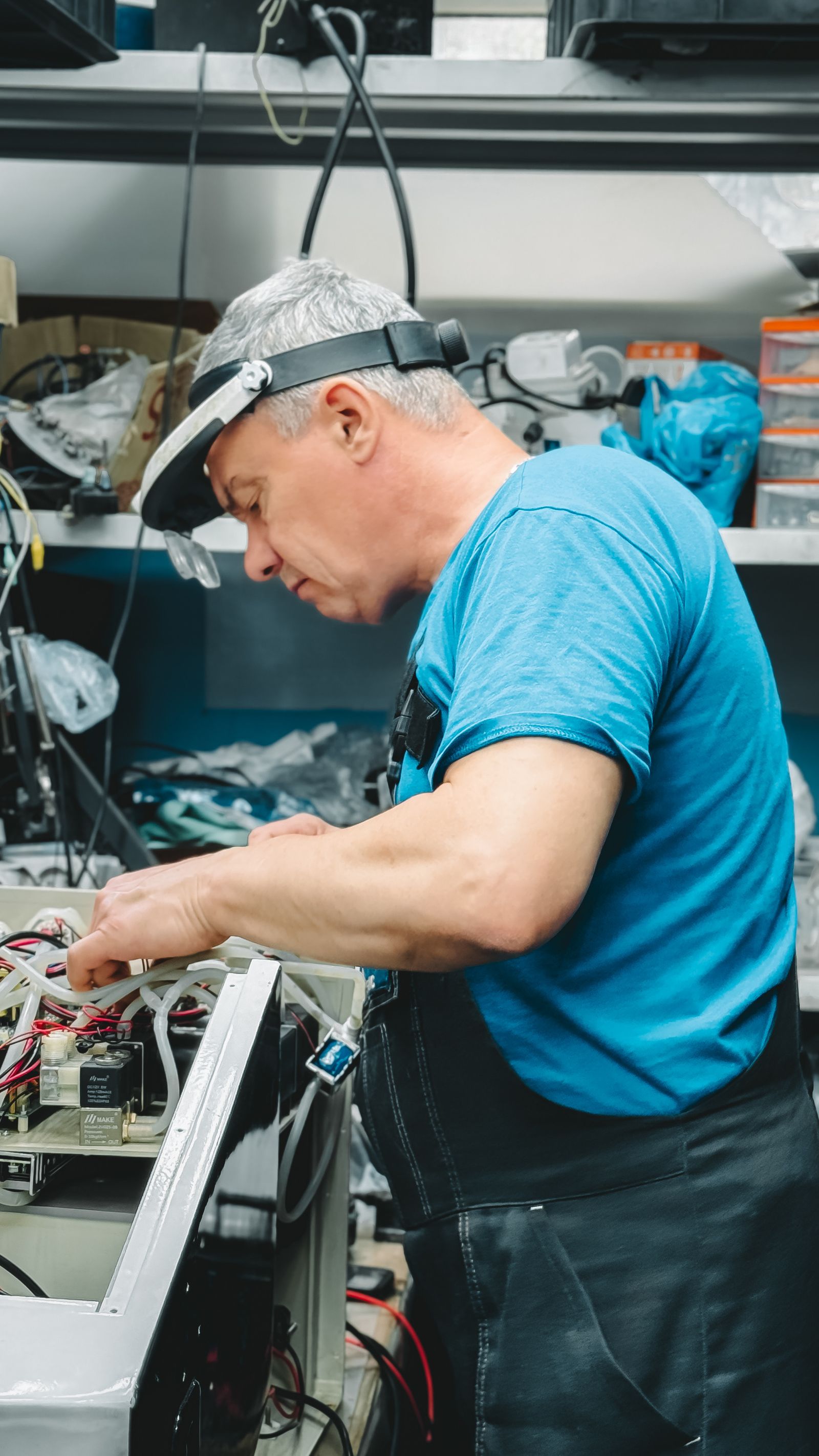 Technician repairing electronics in a workshop — TVCare Mumbai sound/speaker repair service in Thane