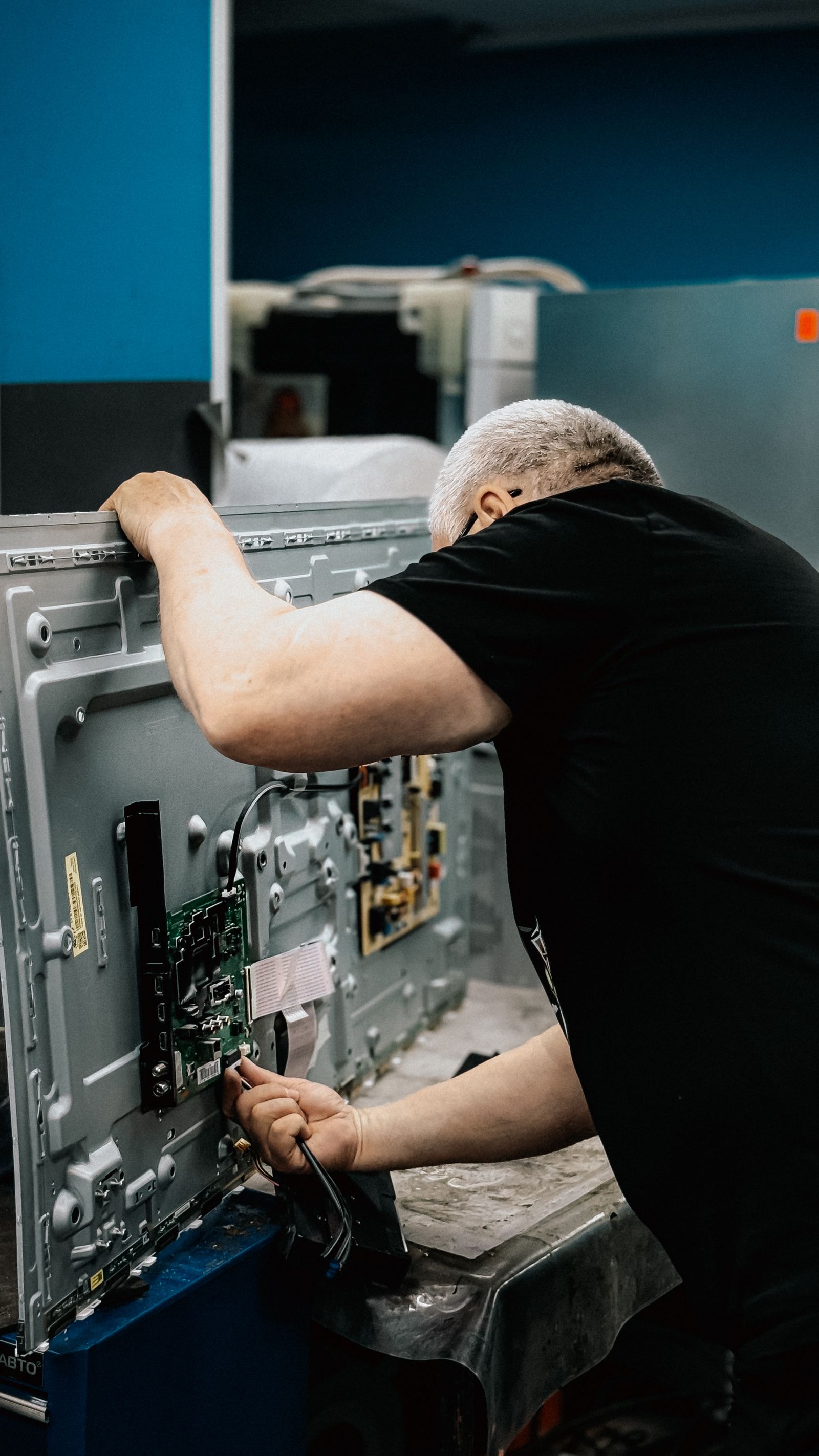 TVCare Mumbai technician repairing a TV circuit board